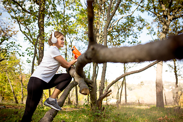 Image showing Disabled woman walking down and training outdoors in forest