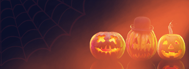 Image showing Scary pumpkins on dark orange background, the night of fear