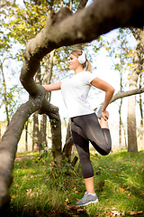 Image showing Disabled woman walking down and training outdoors in forest