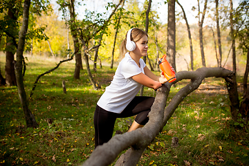 Image showing Disabled woman walking down and training outdoors in forest