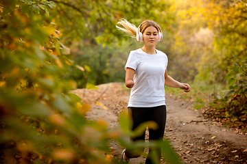 Image showing Disabled woman walking down and training outdoors in forest