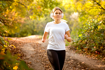 Image showing Disabled woman walking down and training outdoors in forest