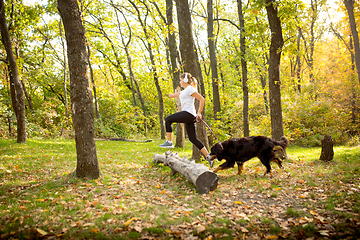 Image showing Disabled woman walking down and training outdoors in forest