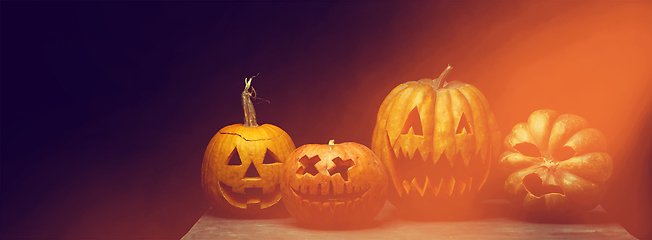 Image showing Scary pumpkins on dark orange background, the night of fear