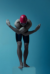 Image showing Professional male swimmer with hat and goggles in motion and action, healthy lifestyle and movement concept. Neoned style.