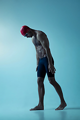 Image showing Professional male swimmer with hat and goggles in motion and action, healthy lifestyle and movement concept. Neoned style.