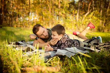 Image showing Father and son walking and having fun in autumn forest, look happy and sincere