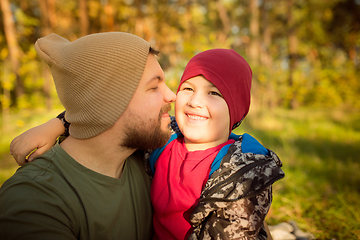 Image showing Father and son walking and having fun in autumn forest, look happy and sincere