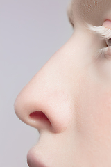 Image showing Close up portrait of beautiful albino woman isolated on studio background. Beauty, fashion, skincare, cosmetics concept. Details.