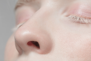 Image showing Close up portrait of beautiful albino woman isolated on studio background. Beauty, fashion, skincare, cosmetics concept. Details.