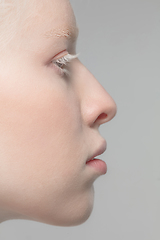 Image showing Close up portrait of beautiful albino woman isolated on studio background. Beauty, fashion, skincare, cosmetics concept. Details.