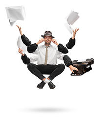 Image showing Handsome multi-armed journalist levitating isolated on yellow studio background with equipment