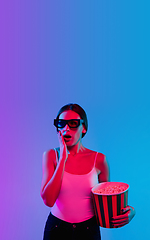 Image showing Young caucasian woman\'s portrait on gradient blue-purple studio background in neon light