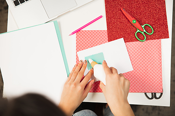 Image showing Woman making greeting card for New Year and Christmas 2021 for friends or family, scrap booking, DIY