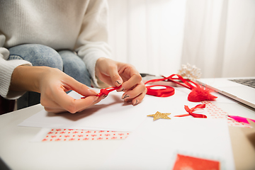 Image showing Woman making greeting card for New Year and Christmas 2021 for friends or family, scrap booking, DIY