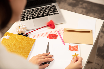 Image showing Woman making greeting card for New Year and Christmas 2021 for friends or family, scrap booking, DIY