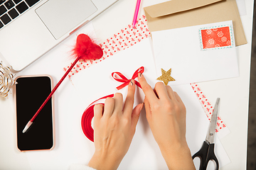 Image showing Woman making greeting card for New Year and Christmas 2021 for friends or family, scrap booking, DIY