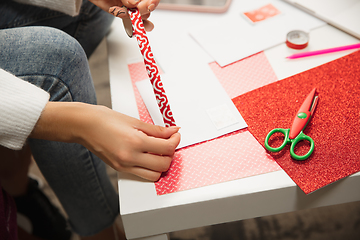 Image showing Woman making greeting card for New Year and Christmas 2021 for friends or family, scrap booking, DIY