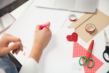 Image showing Woman making greeting card for New Year and Christmas 2021 for friends or family, scrap booking, DIY