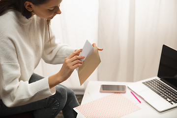 Image showing Woman making greeting card for New Year and Christmas 2021 for friends or family, scrap booking, DIY