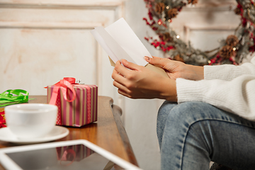 Image showing Woman opening, recieving greeting card for New Year and Christmas 2021 from friends or family