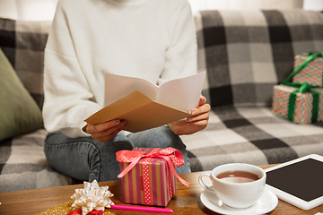 Image showing Woman opening, recieving greeting card for New Year and Christmas 2021 from friends or family