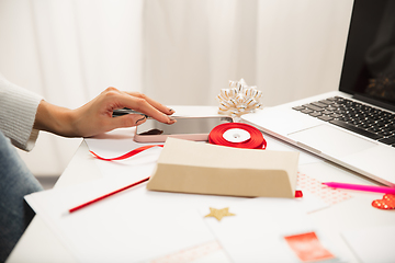 Image showing Woman making greeting card for New Year and Christmas 2021 for friends or family, scrap booking, DIY