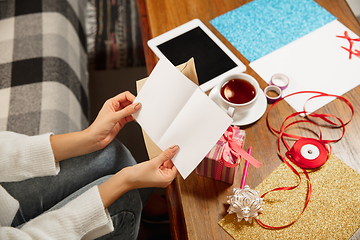 Image showing Woman opening, recieving greeting card for New Year and Christmas 2021 from friends or family