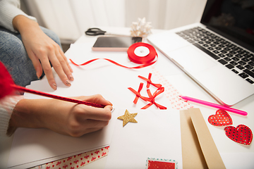 Image showing Woman making greeting card for New Year and Christmas 2021 for friends or family, scrap booking, DIY