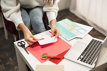 Image showing Woman making greeting card for New Year and Christmas 2021 for friends or family, scrap booking, DIY