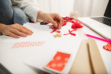 Image showing Woman making greeting card for New Year and Christmas 2021 for friends or family, scrap booking, DIY