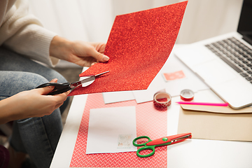 Image showing Woman making greeting card for New Year and Christmas 2021 for friends or family, scrap booking, DIY