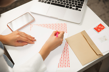 Image showing Woman making greeting card for New Year and Christmas 2021 for friends or family, scrap booking, DIY