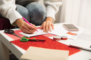 Image showing Woman making greeting card for New Year and Christmas 2021 for friends or family, scrap booking, DIY