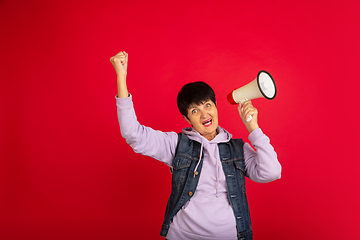 Image showing Senior woman isolated on red background. Tech and joyful elderly lifestyle concept