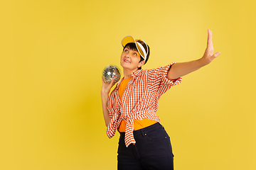 Image showing Senior woman isolated on yellow background. Tech and joyful elderly lifestyle concept