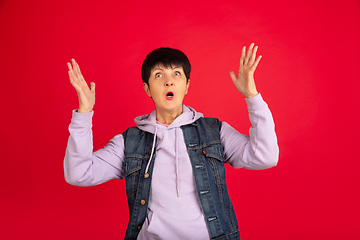 Image showing Senior woman isolated on red background. Tech and joyful elderly lifestyle concept