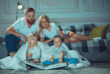 Image showing Mother, father and kids at home having fun, comfort and cozy concept