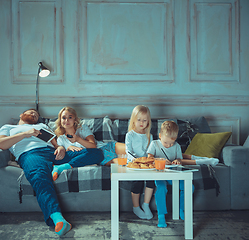 Image showing Mother, father and kids at home having fun, comfort and cozy concept