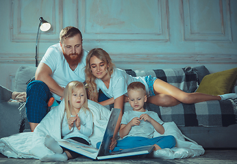 Image showing Mother, father and kids at home having fun, comfort and cozy concept