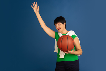 Image showing Senior woman isolated on blue background. Tech and joyful elderly lifestyle concept