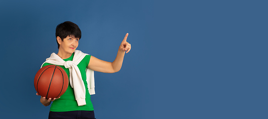 Image showing Senior woman isolated on blue background. Tech and joyful elderly lifestyle concept