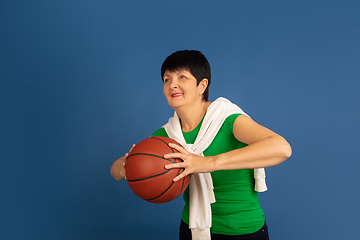 Image showing Senior woman isolated on blue background. Tech and joyful elderly lifestyle concept