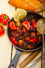 Image showing Baby cuttle fish roasted on iron skillet