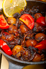 Image showing Baby cuttle fish roasted on iron skillet