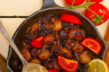 Image showing Baby cuttle fish roasted on iron skillet