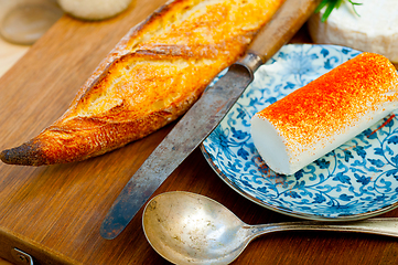 Image showing French cheese and fresh  baguette on a wood cutter