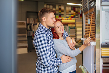 Image showing Couple choosing textile at home decoration store, shop. Making of home interior design during quarantine