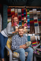 Image showing Couple choosing textile at home decoration store, shop. Making of home interior design during quarantine