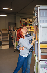 Image showing Couple choosing textile at home decoration store, shop. Making of home interior design during quarantine